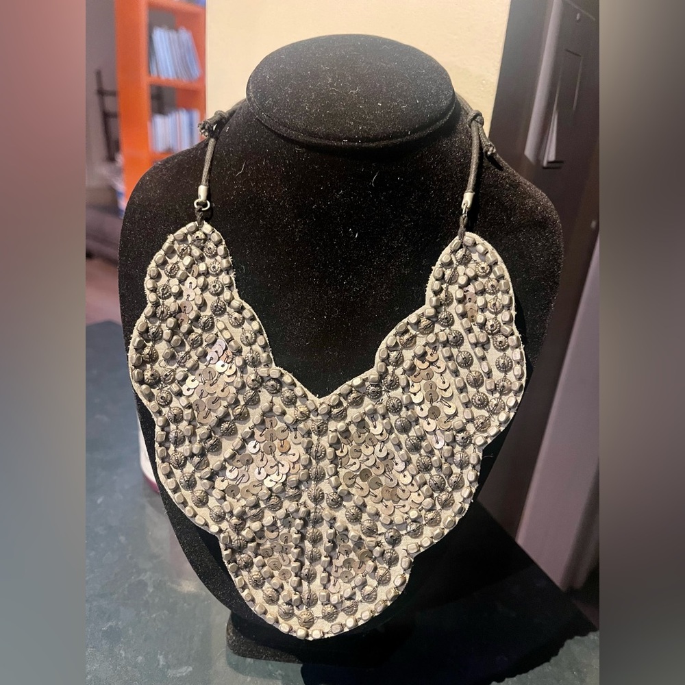 Statement necklace with detailed beads on leather.
